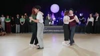 a group of people dancing on a dance floor