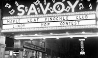 a black and white photo of a theater with a sign that says savoy